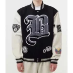 Model in Brooklyn Nets 12 Black Varsity Jacket, front view