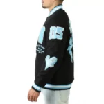 Model in Cherub Rock Rebel black varsity jacket, front view