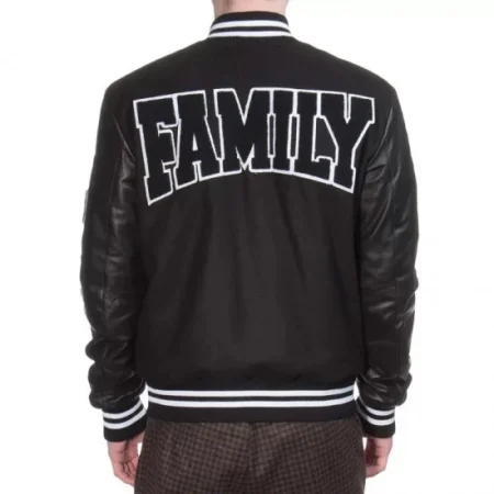 Model wearing Family First Black Varsity Jacket back view