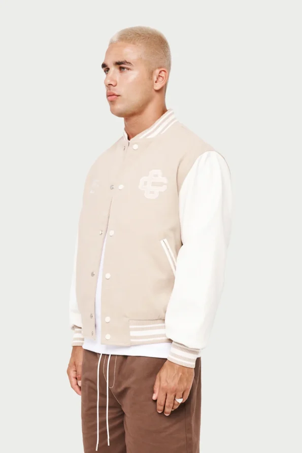 cream and white varsity jacket