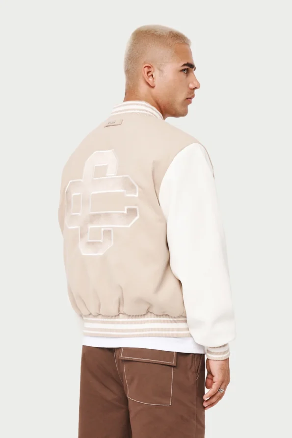 cream and white varsity jacket