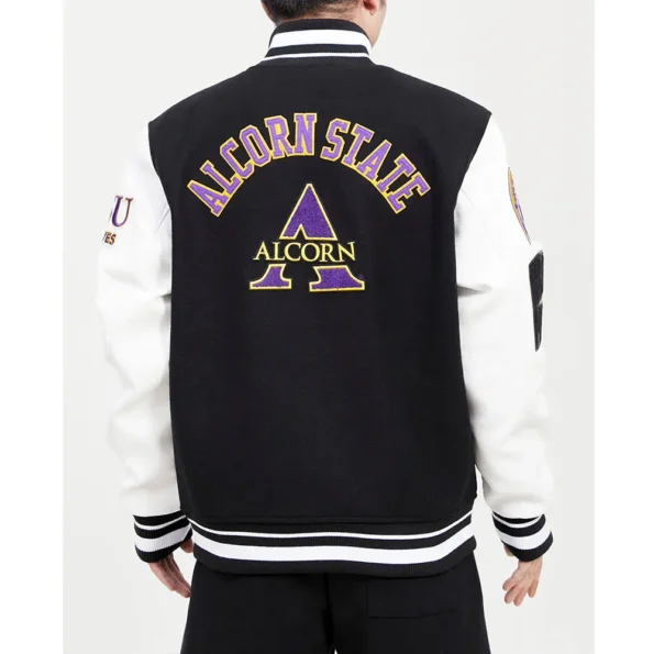 Model wearing Alcorn State University Varsity Jacket back view.