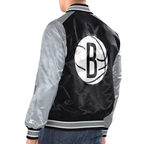 Model back view Brooklyn Nets Renegade Varsity Jacket bold logo