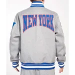 Model wearing NY Giants Crest Gray Varsity Jacket front view.