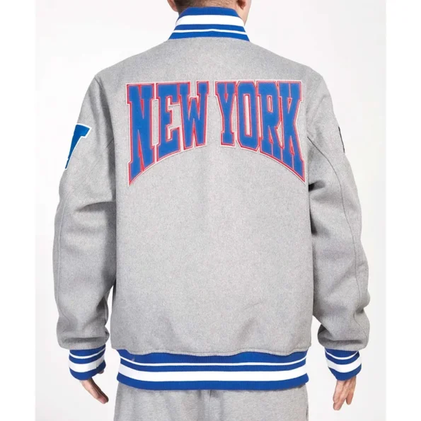 Model wearing NY Giants Crest Gray Varsity Jacket back view.