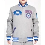 Model wearing NY Giants Crest Gray Varsity Jacket front view.