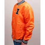 Model showcasing front view of Illinois Fighting Illini varsity jacket.