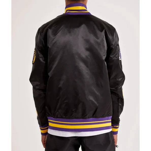 Model back view wearing LA Lakers 17X Champions Varsity Jacket