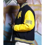 Model in North Carolina AT State Varsity Jacket front.