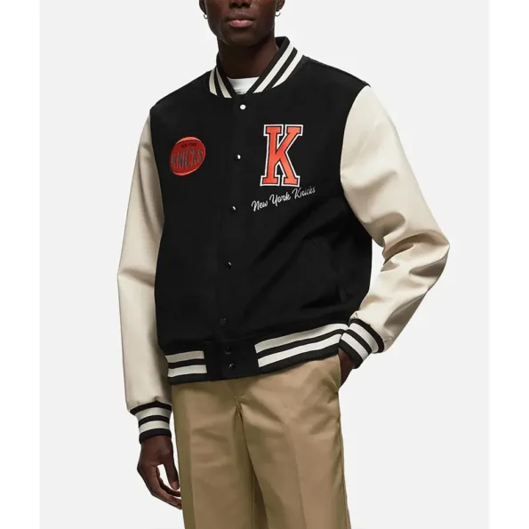 Side profile of model wearing NY Knicks Black Varsity Jacket.