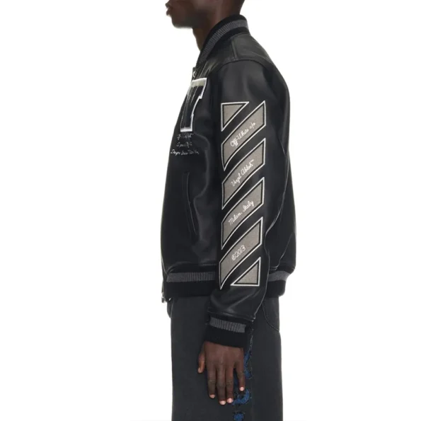 Side profile of model wearing Full Black Leather Varsity Jacket.