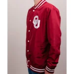 Model showcasing front view of Oklahoma Boomer Sooners varsity jacket.