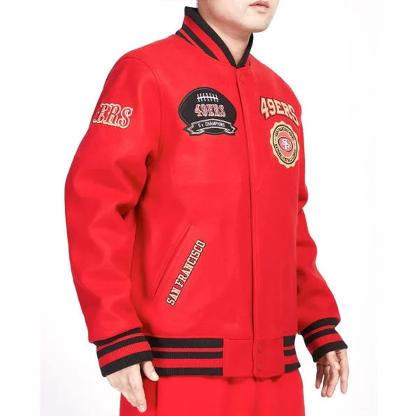 Model wearing San Francisco 49ers Crest Varsity Jacket side view.