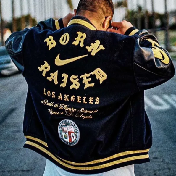 Model wearing Born Raised Los Angeles Varsity Jacket back view