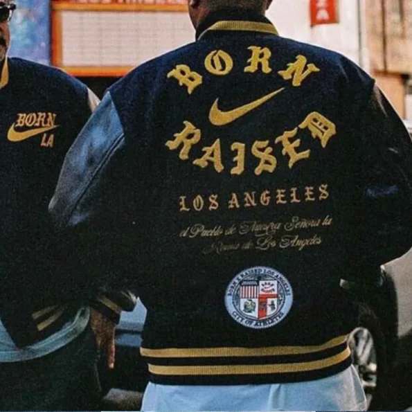 Model wearing Born Raised Los Angeles Varsity Jacket back view