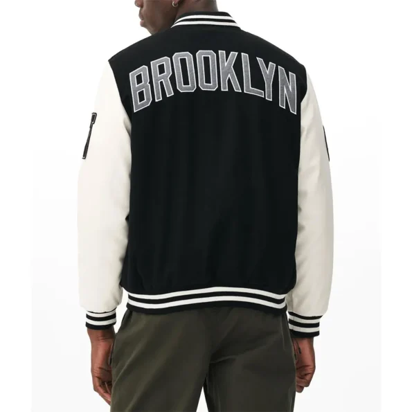 Model wearing Brooklyn Nets Varsity Black Jacket back