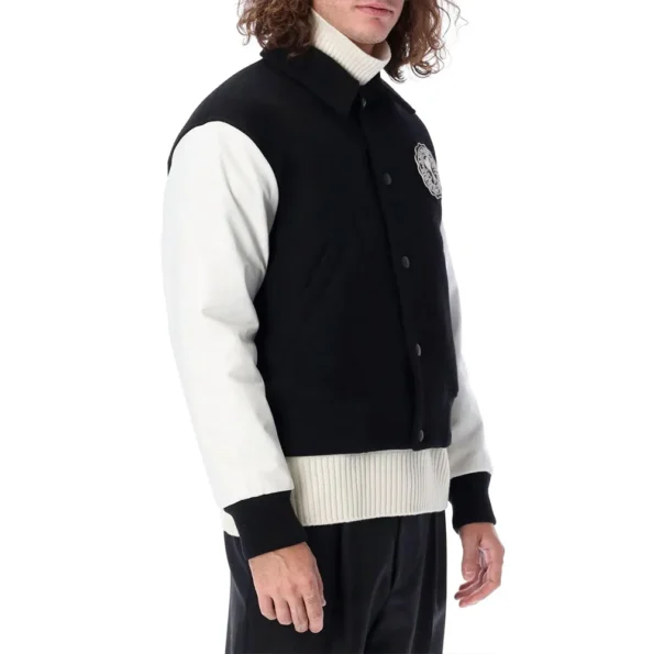 Side view of model in Ami Black and White Varsity Jacket