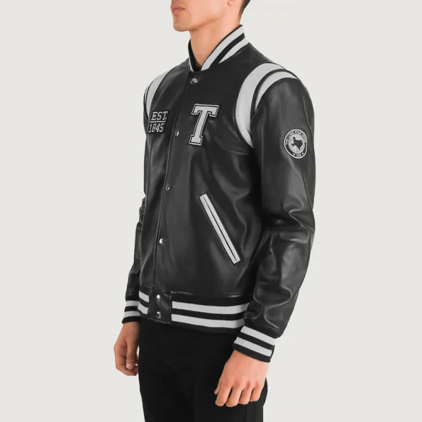 Side view of model in Liberte Texas Black Varsity Jacket