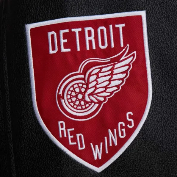 Zoomed view of Detroit Red Wings black varsity jacket details.