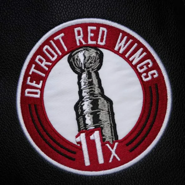 Zoomed view of Detroit Red Wings black varsity jacket details.