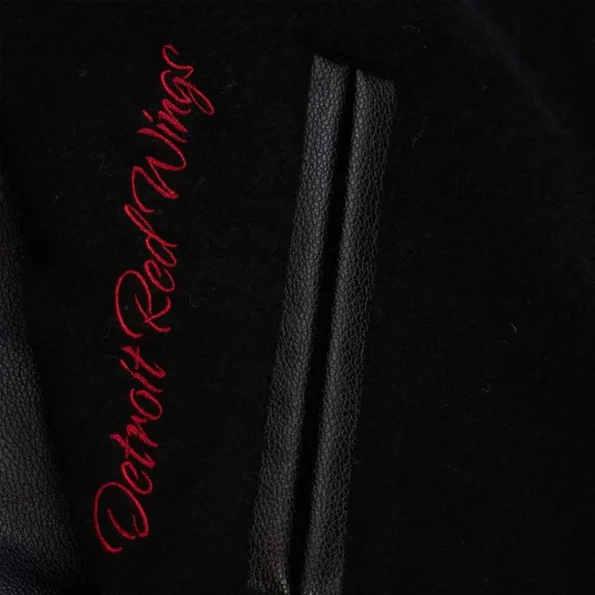 Zoomed view of Detroit Red Wings black varsity jacket details.