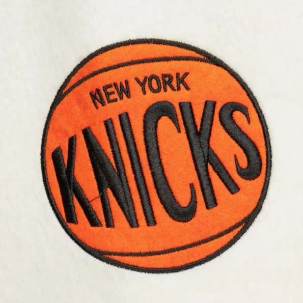 Zoomed view of NY Knicks team history varsity jacket details.