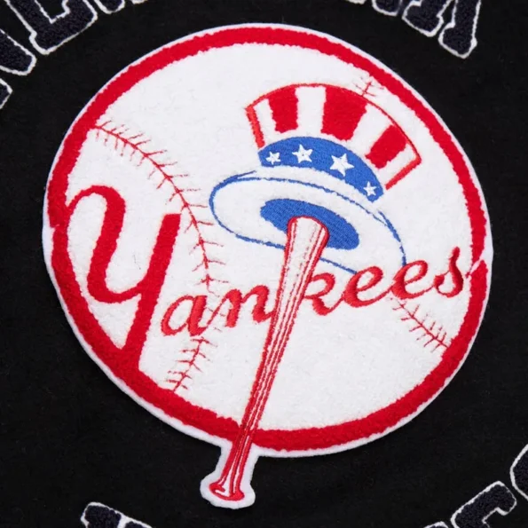 Zoomed view of NY Yankees black vintage varsity jacket details.