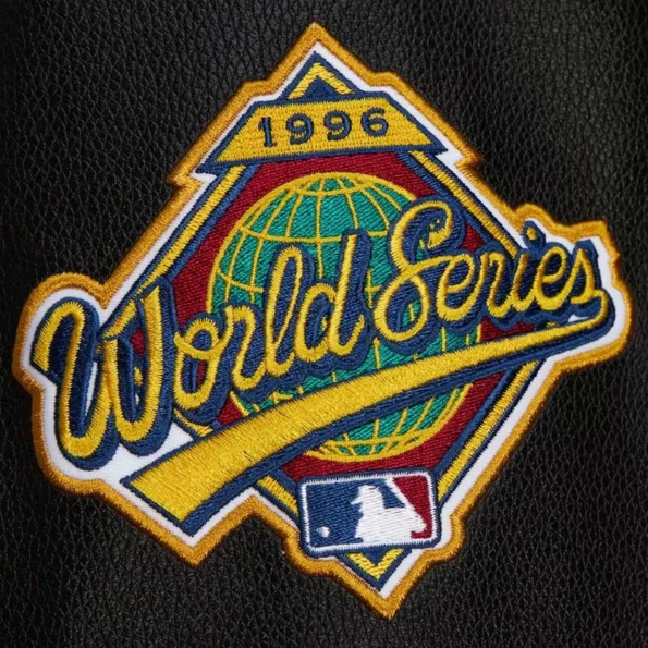 Zoomed view of NY Yankees black vintage varsity jacket details.