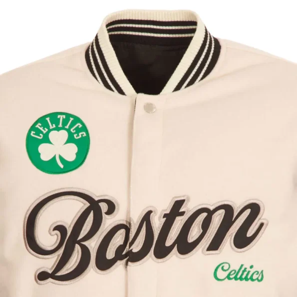 Close-up of Boston Celtics cream varsity jacket embroidery.