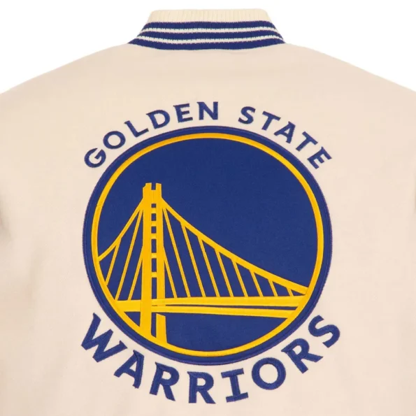 Close-up of Golden State Warriors cream varsity jacket embroidery.
