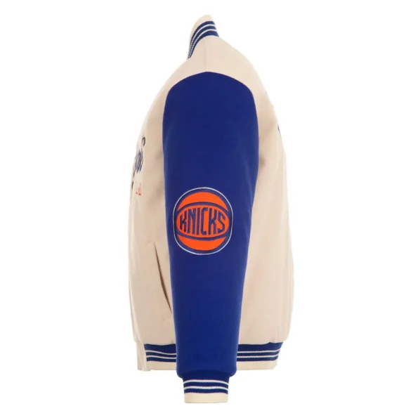 Side view of NY Knicks cream and royal varsity jacket.