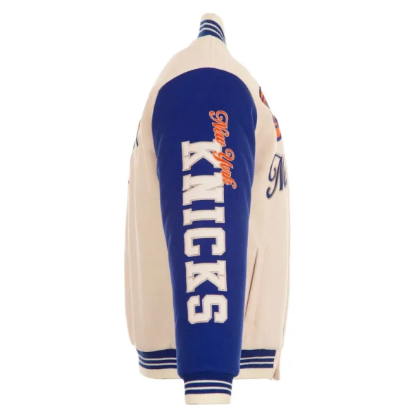 Side view of NY Knicks cream and royal varsity jacket.