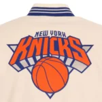 Front view NY Knicks cream and royal varsity jacket photo.