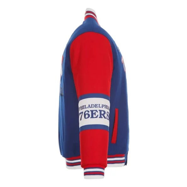 Side view of Philadelphia 76ers royal varsity jacket.